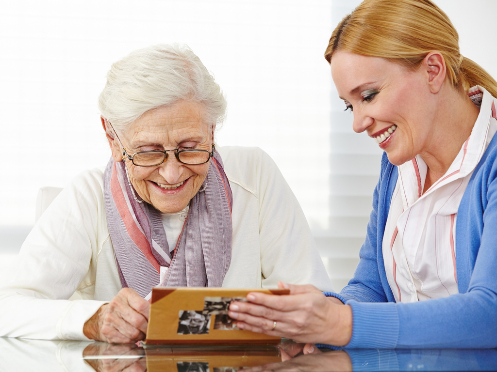 Caregiver providing dementia care to senior