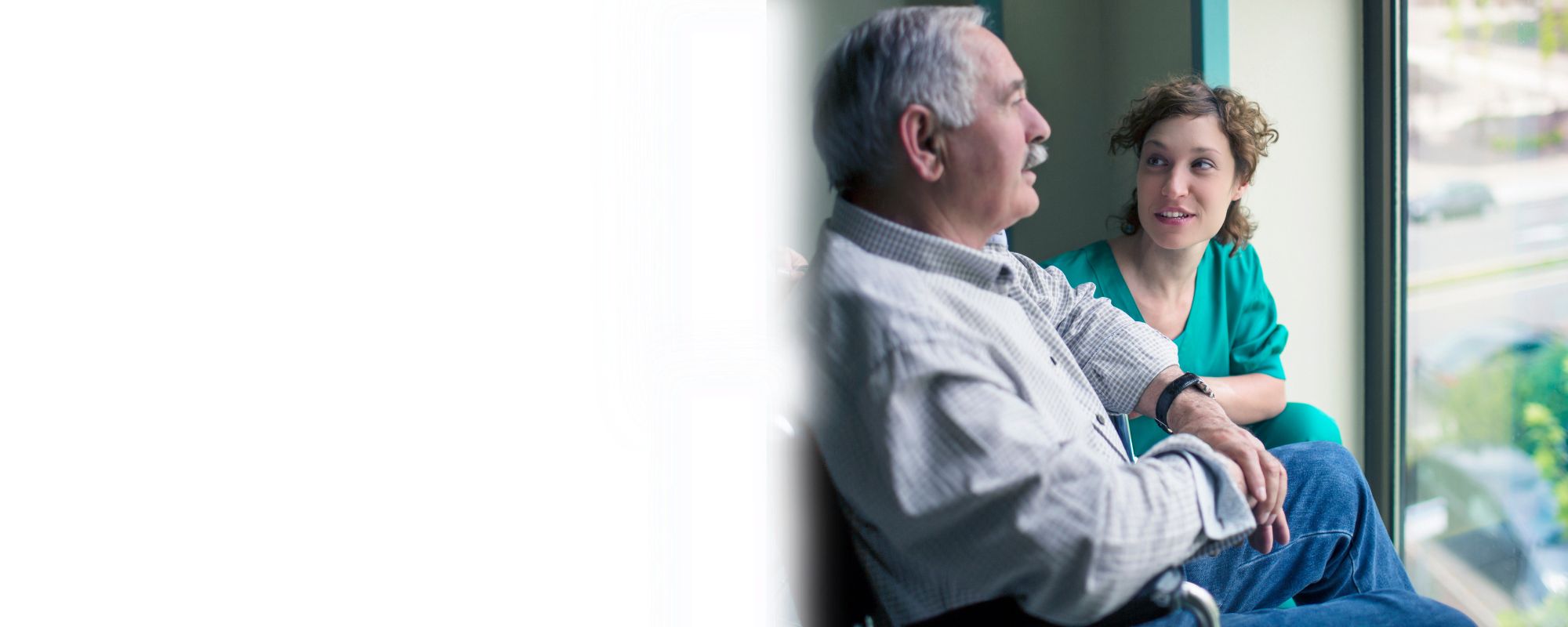 Compassionate Home Care Support for Seniors in Lawrence, WV Caregiver talking with a senior man while providing supportive home care in Lawrence, WV