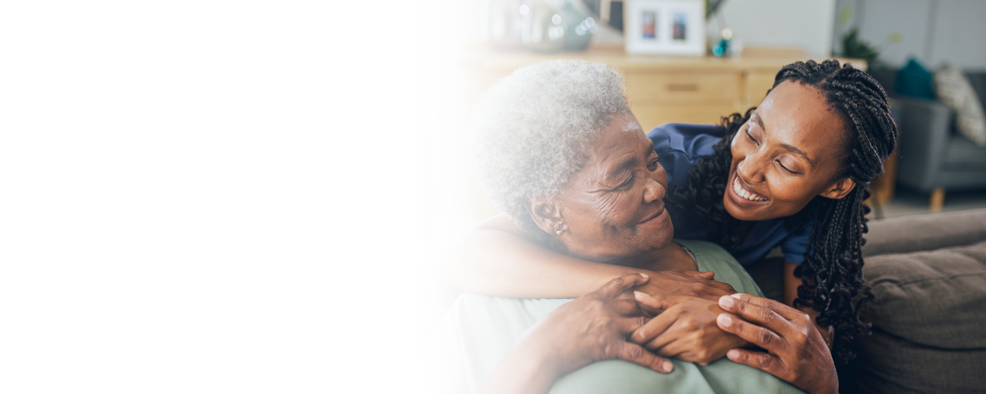 Caregiver embracing senior woman in living room – Home Care in Barbour County, WV Caregiver embracing senior woman in living room - Home Care in Barbour County, WV