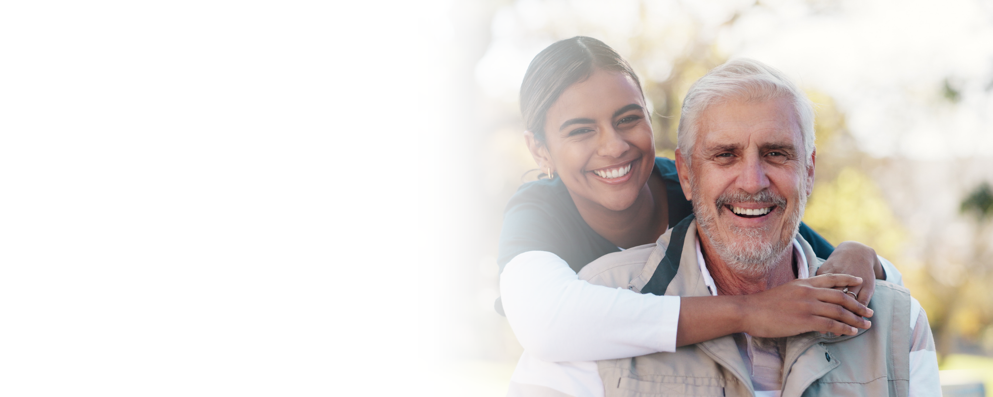Caregiver hugging senior man outdoors in park – Home Care in Berkeley County Caregiver hugging senior man outdoors in park - Home Care in Berkeley County